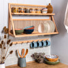 The ridgewood plate rack being used to store and display a range of kitchenware items, including plates, bowls, storage jars and a wooden chopping board. Under neath there is a peg rail and utensils pot. 