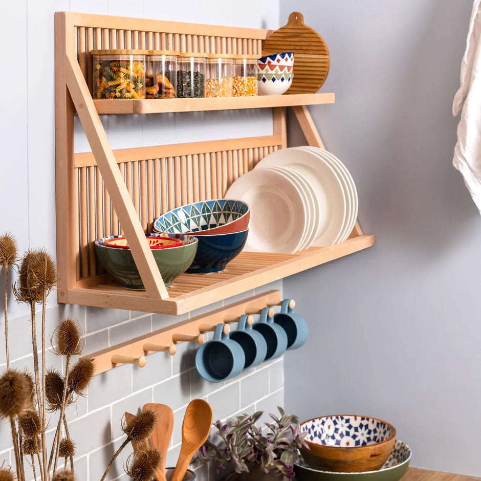 Our flag ship wall mounted plate storage rack being used to store plates, cups, bowls and jars. A peg rail sits beneath. 