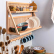 Our flag ship wall mounted plate storage rack being used to store plates, cups, bowls and jars. A peg rail sits beneath. 