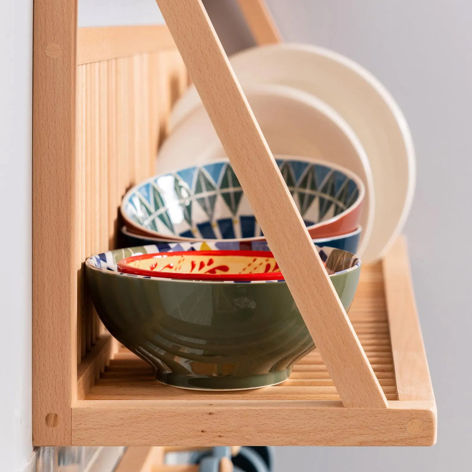 Side on view of our kitchen plate rack with bowels and plates being displayed. The detail of the wood is on show. 